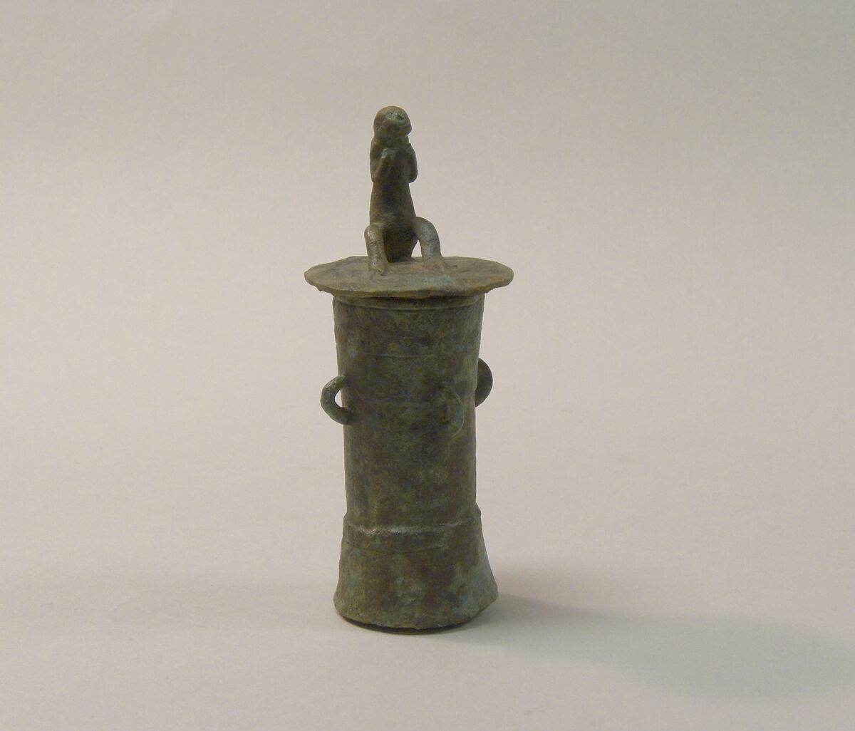 Lime Container in the Form of a "Mloko" Drum Surmounted by a Crouching Figure, Bronze, Indonesia (Java, Lumajang, Pasiran) 