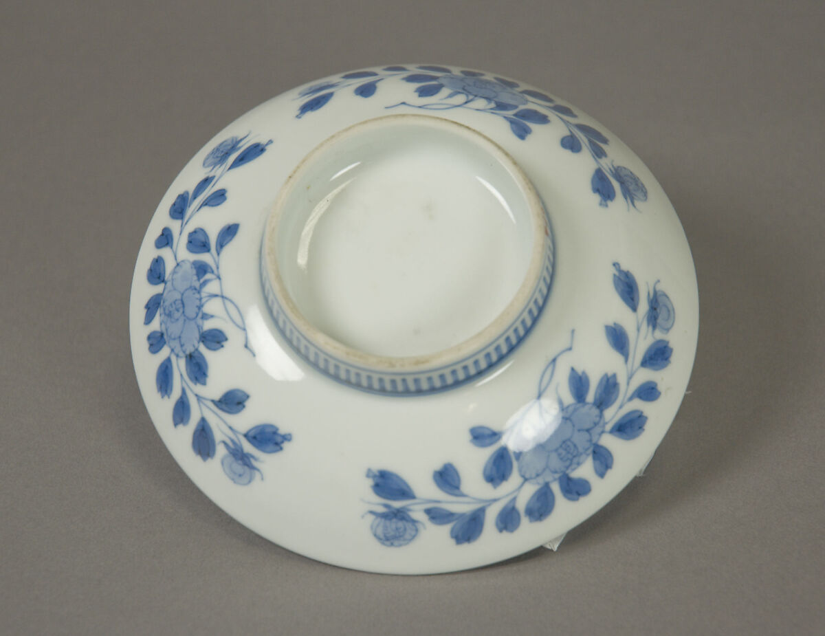 Dish with Fish in a Stream, White porcelain decorated with blue under the glaze; comb pattern round the high foot (Nabeshima ware), Japan