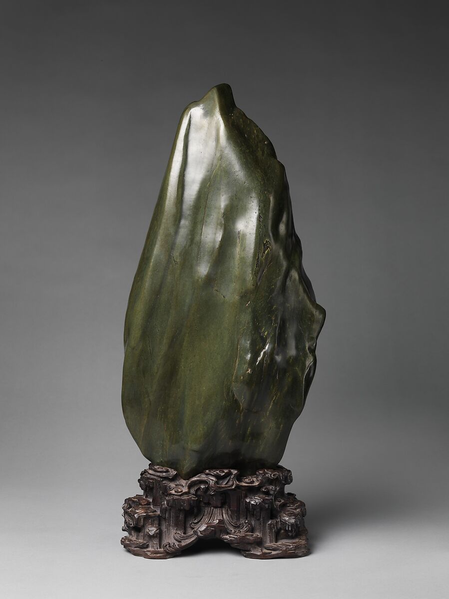 Soaring Peak, Sea-green hornblende with yellow markings; carved wood stand, China