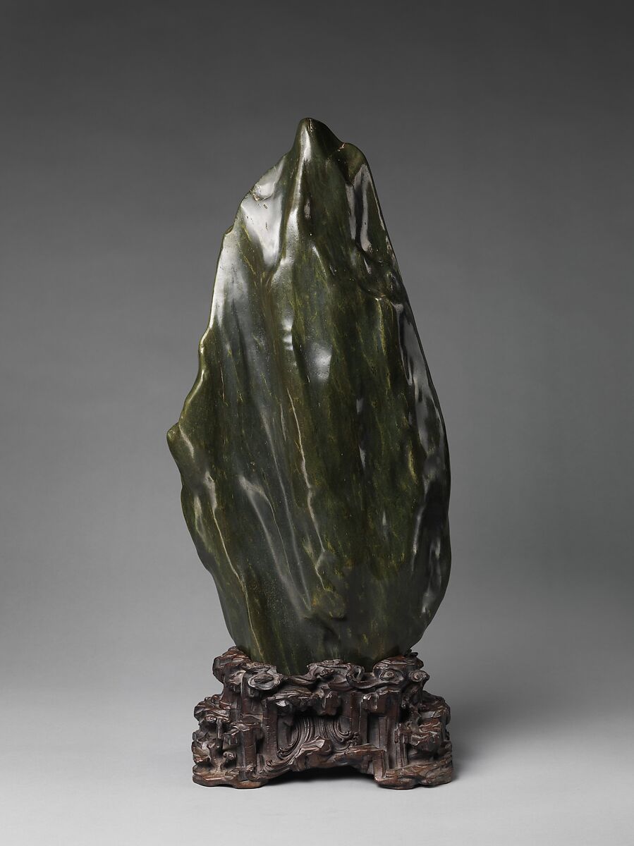 Soaring Peak, Sea-green hornblende with yellow markings; carved wood stand, China 