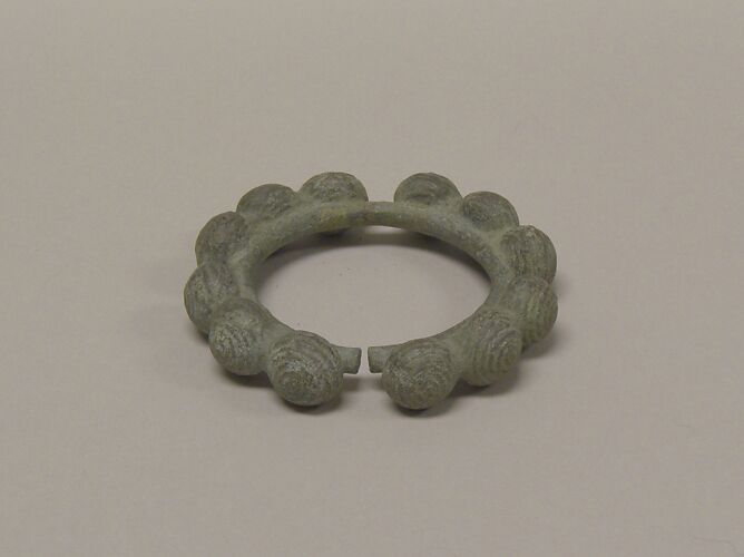 One from a Pair of Bangles with Ball Decorations