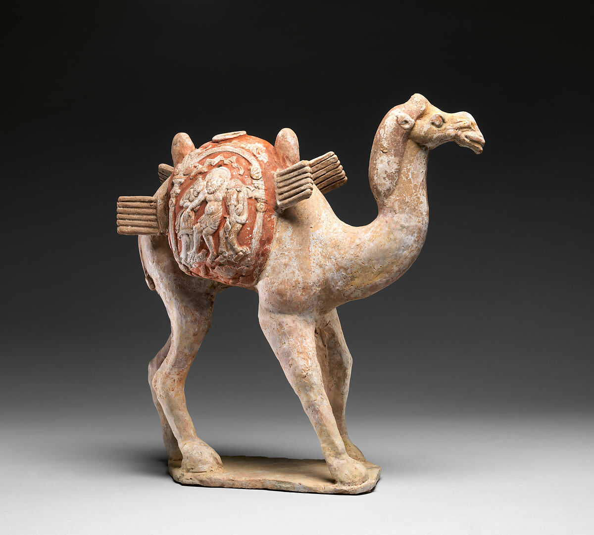 Camel with Dionysian imagery on its saddle bags, Earthenware with appliqué relief decoration and pigment, China