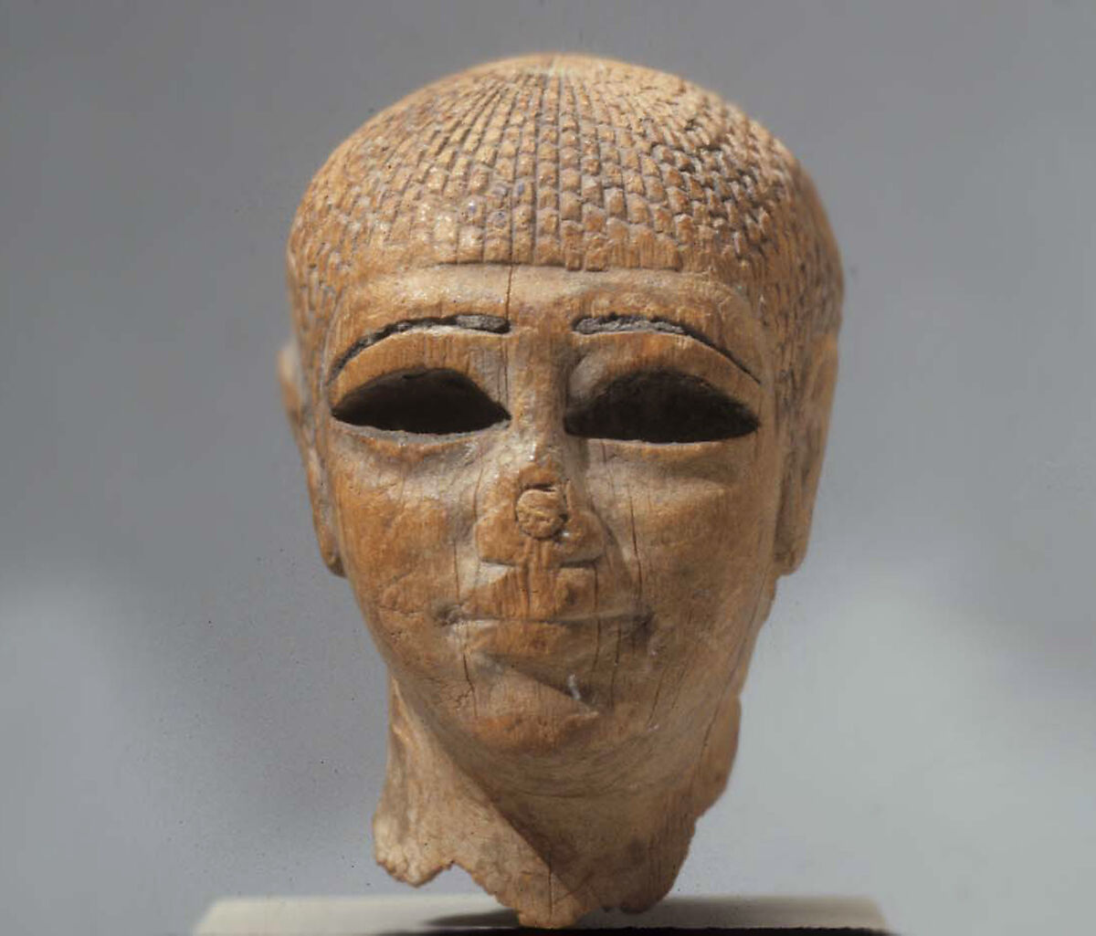 Head of a Female Figure from the Tomb of Khety, Wood, paint and paste fill