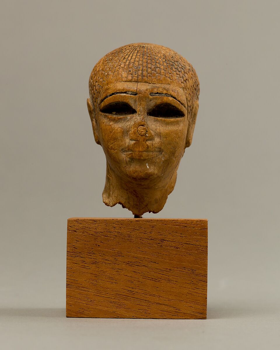 Head of a Female Figure from the Tomb of Khety, Wood, paint and paste fill 