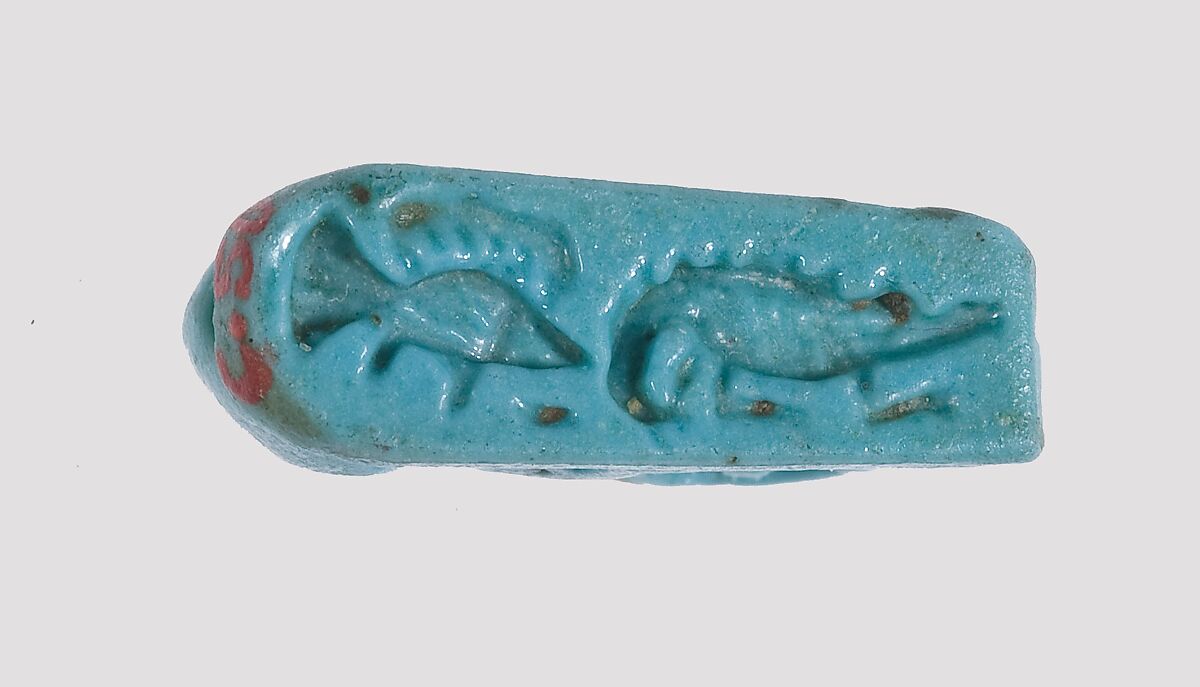 Ibex-Shaped Design Amulet Inscribed With A Crocodile and A Fish, Faience