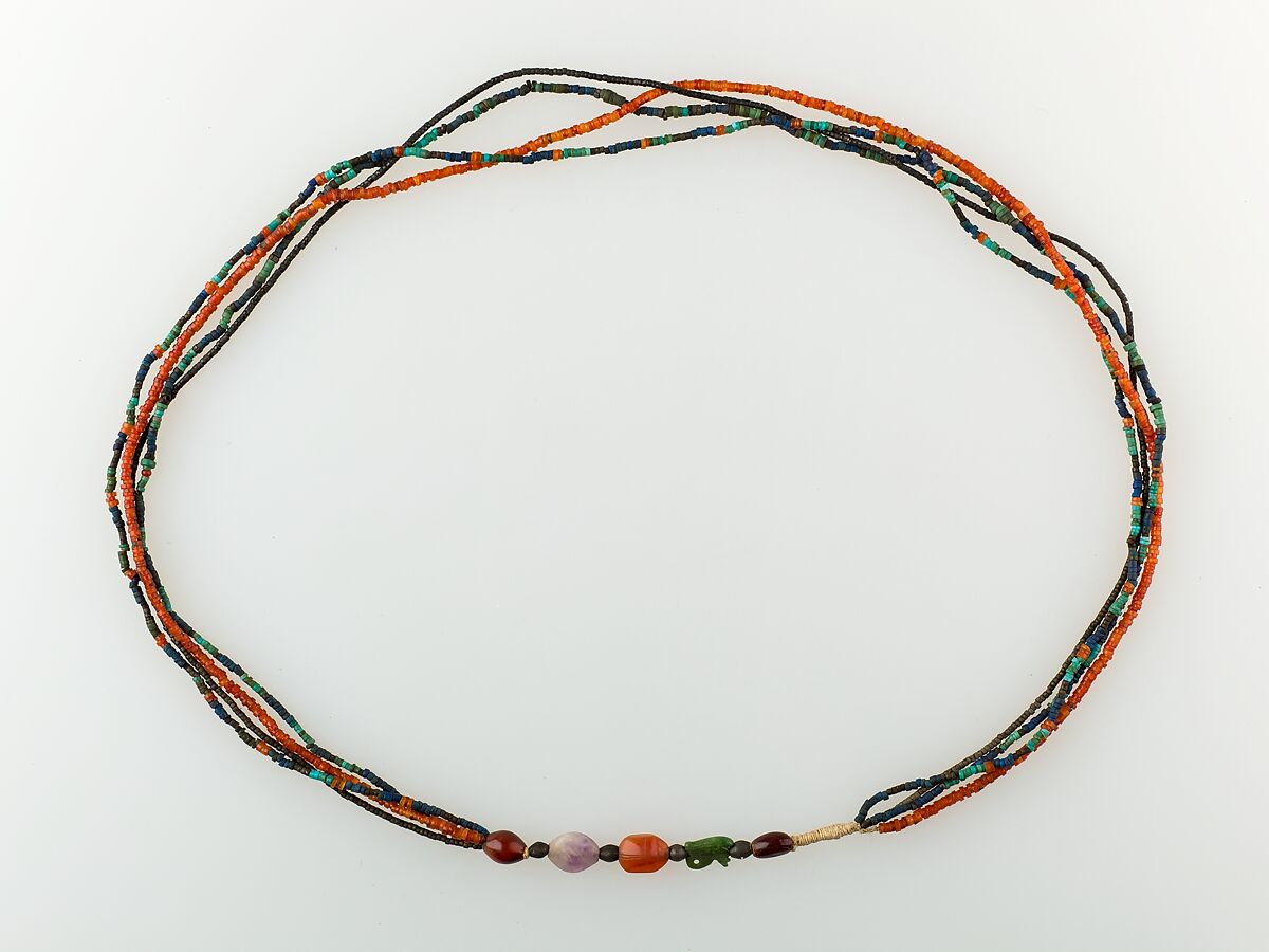A Necklace of four strands of beads and amulets
