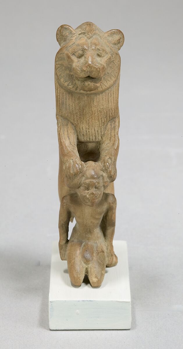 Statuette of lion holding a Nubian captive, Wood
