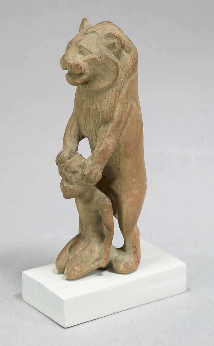 Statuette of lion holding a Nubian captive, Wood