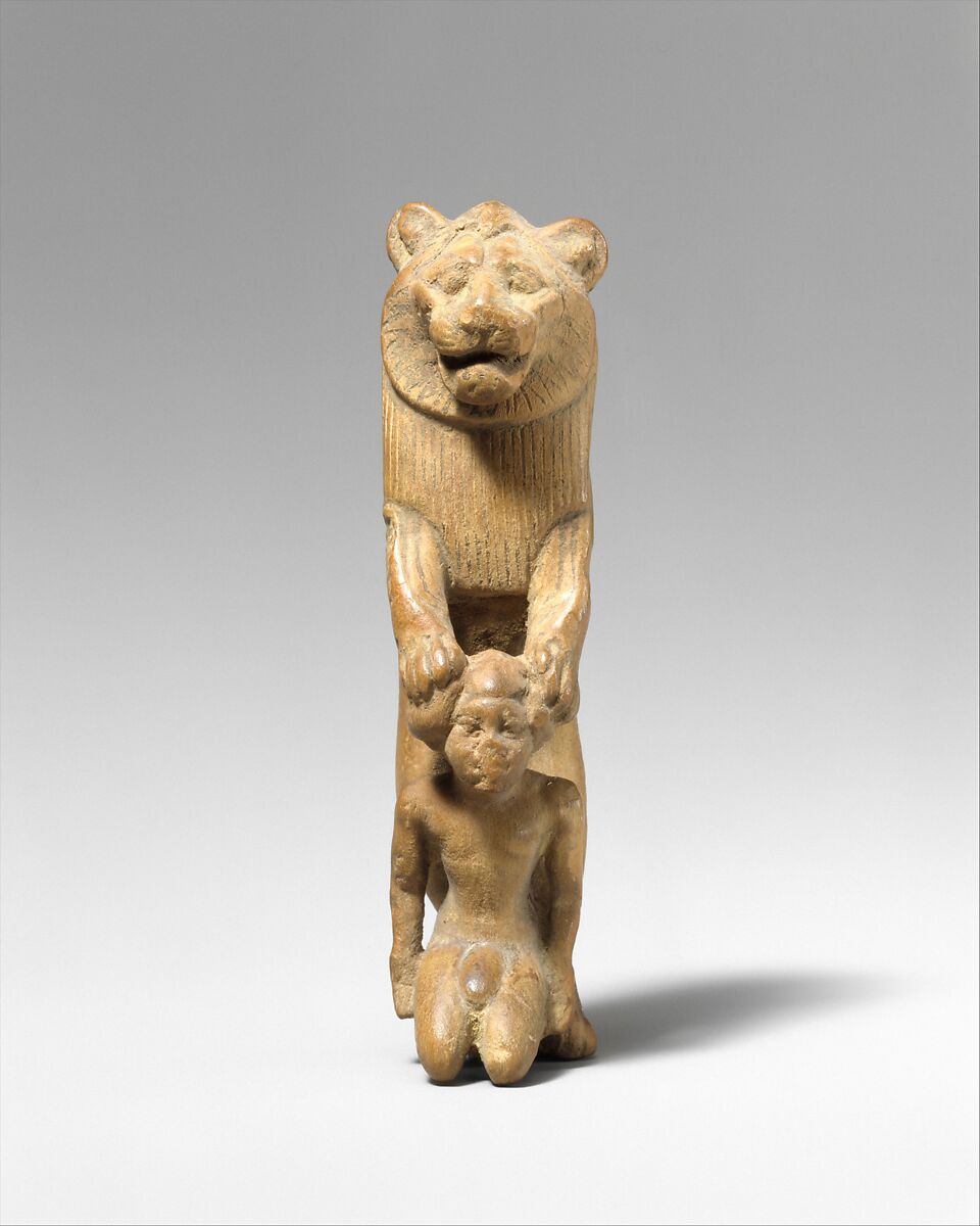 Statuette of lion holding a Nubian captive, Wood
