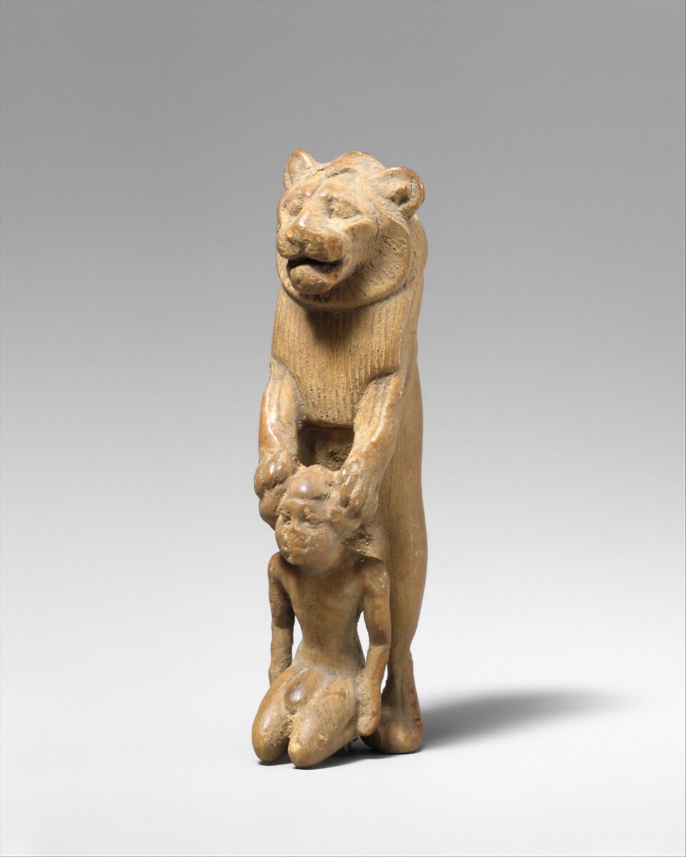 Statuette of lion holding a Nubian captive, Wood