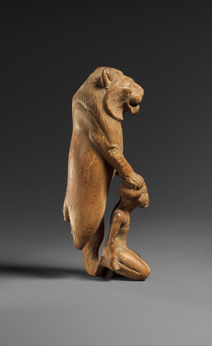 Statuette of lion holding a Nubian captive, Wood