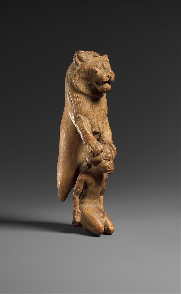 Statuette of lion holding a Nubian captive, Wood