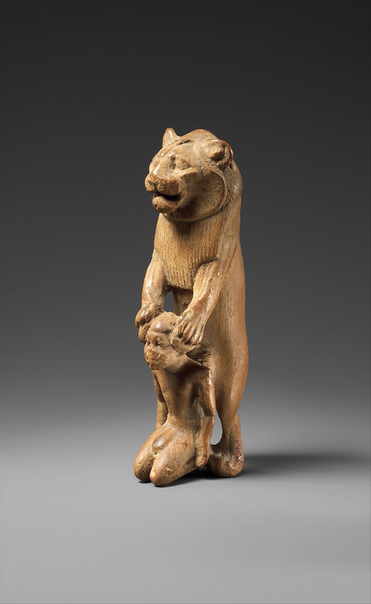 Statuette of lion holding a Nubian captive, Wood 