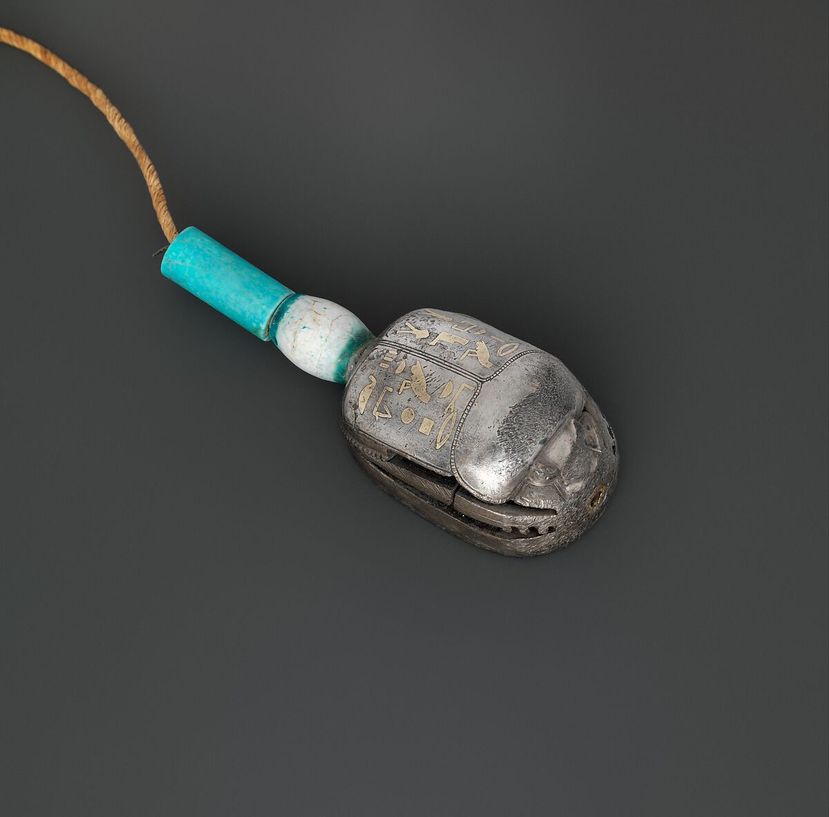 Scarab of the Storehouse Overseer Wah, Silver, electrum, glazed steatite, linen cord