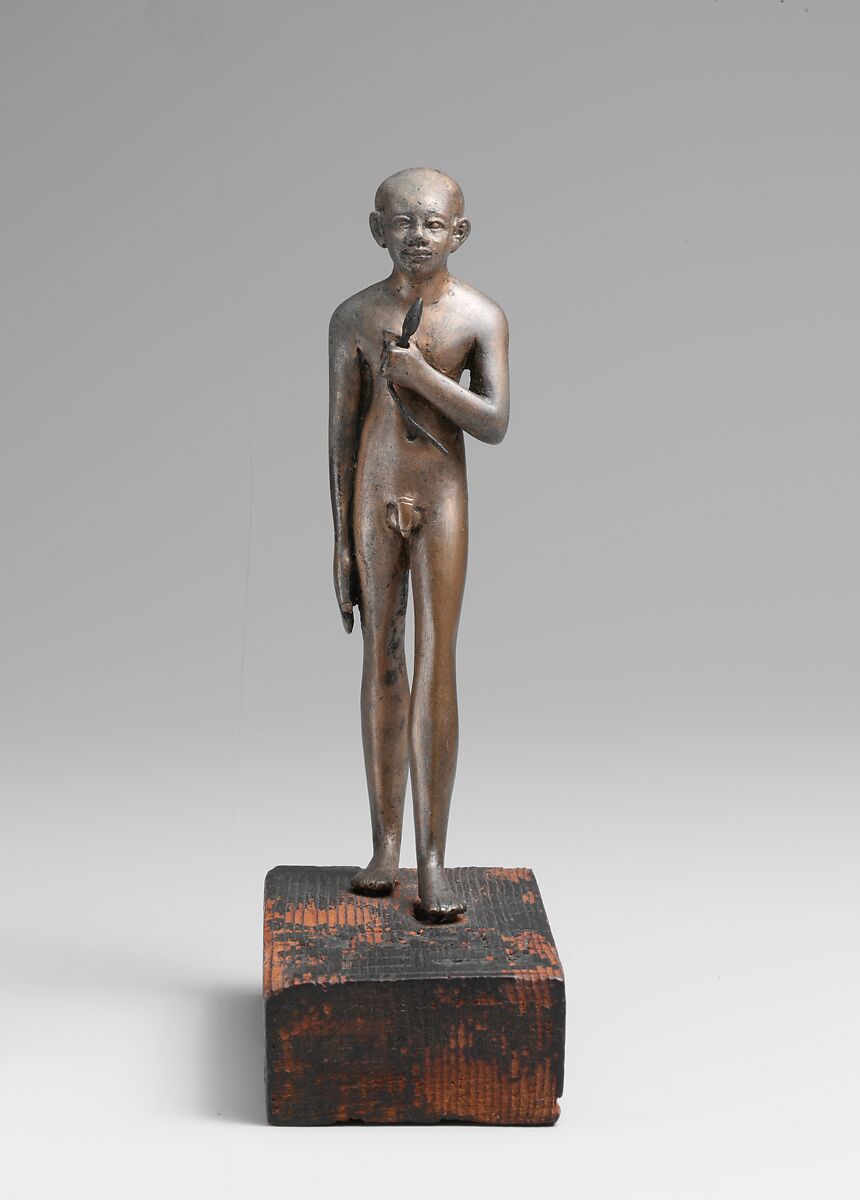 Statuette of the Child Amenemhab, Bronze, separate silver lotus, wood base with pigmented inlays 