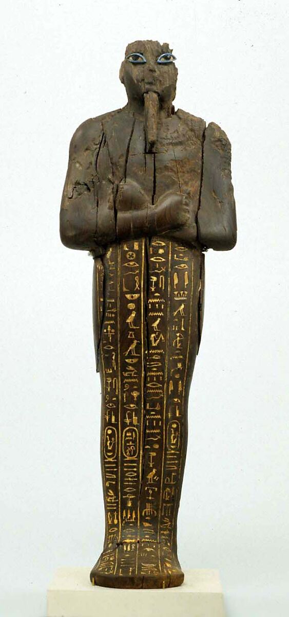 Shabti of Amenhotep III, Ebony; eyes inlaid with blue, white, black glass;  inscription filled with pigment