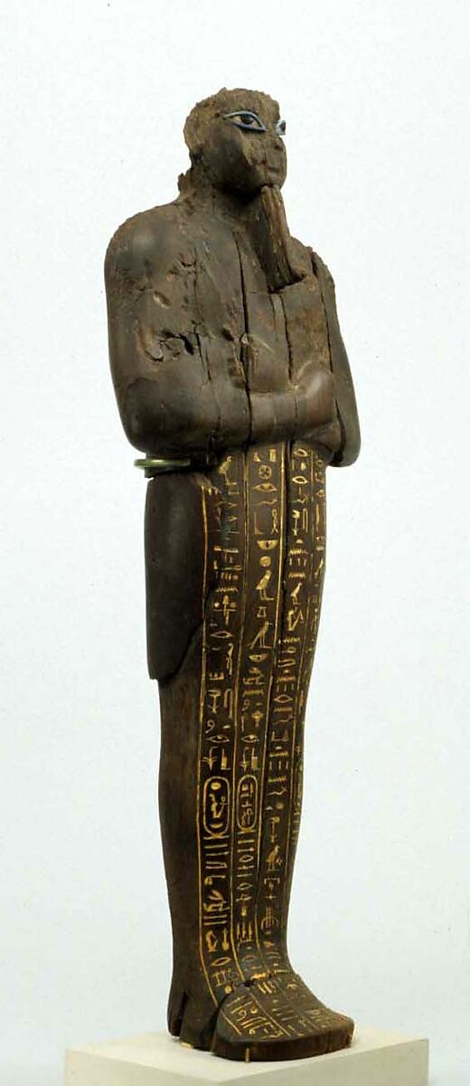 Shabti of Amenhotep III, Ebony; eyes inlaid with blue, white, black glass;  inscription filled with pigment