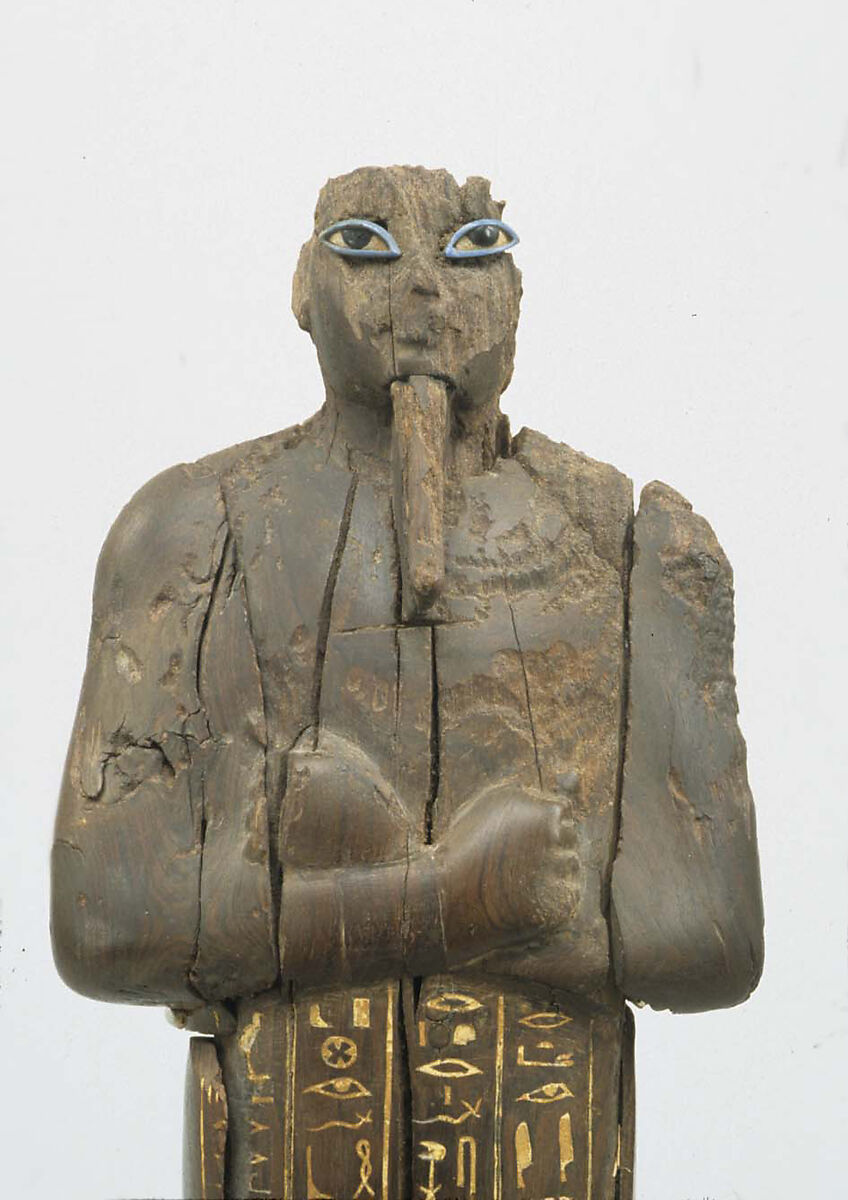 Shabti of Amenhotep III, Ebony; eyes inlaid with blue, white, black glass;  inscription filled with pigment