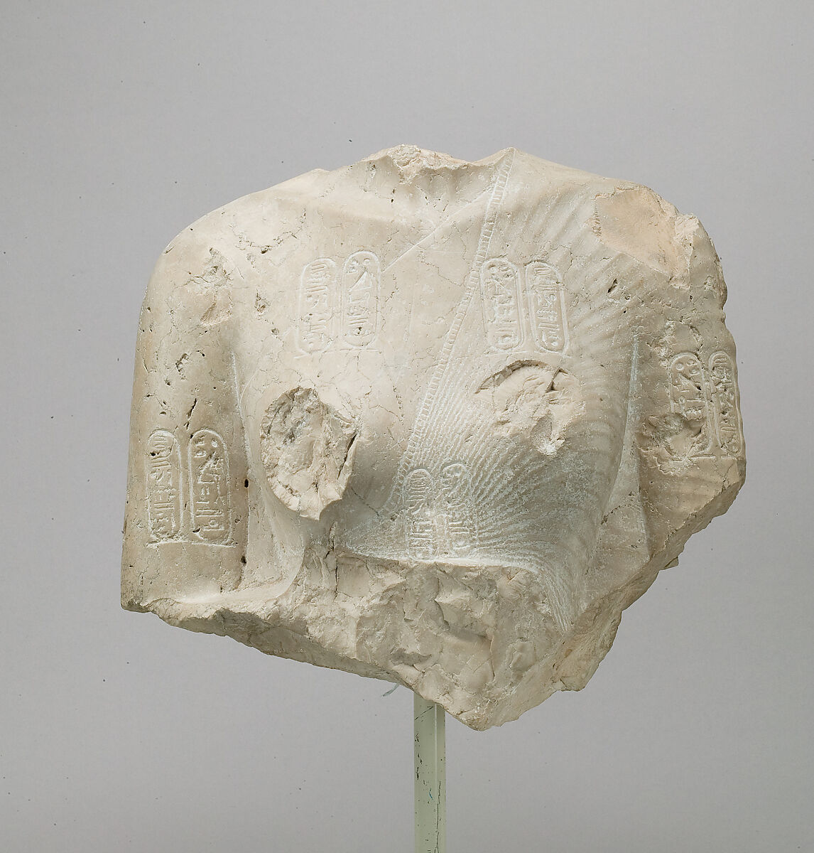 Torso of Nefertiti from a dyad holding a stela in front of the bodies, Indurated limestone