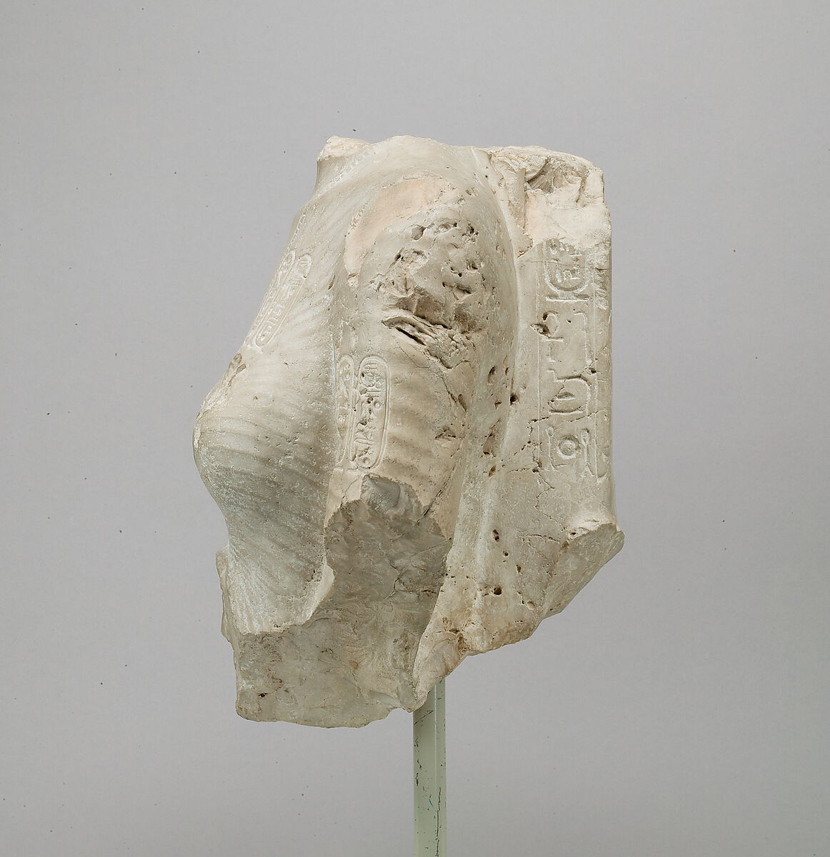 Torso of Nefertiti from a dyad holding a stela in front of the bodies, Indurated limestone