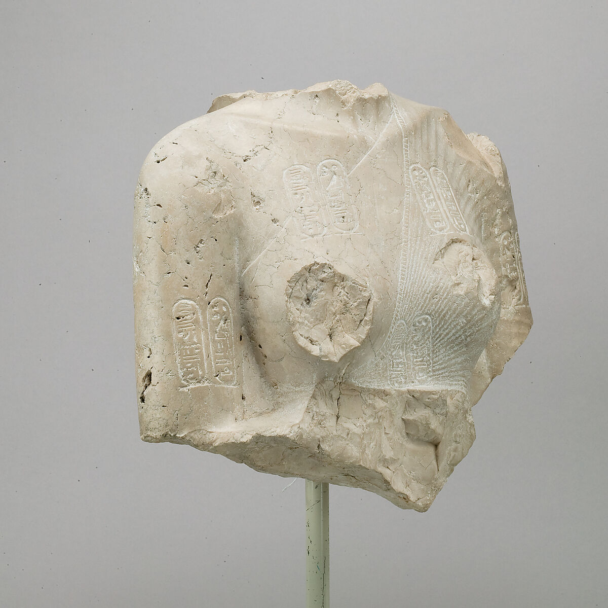 Torso of Nefertiti from a dyad holding a stela in front of the bodies, Indurated limestone