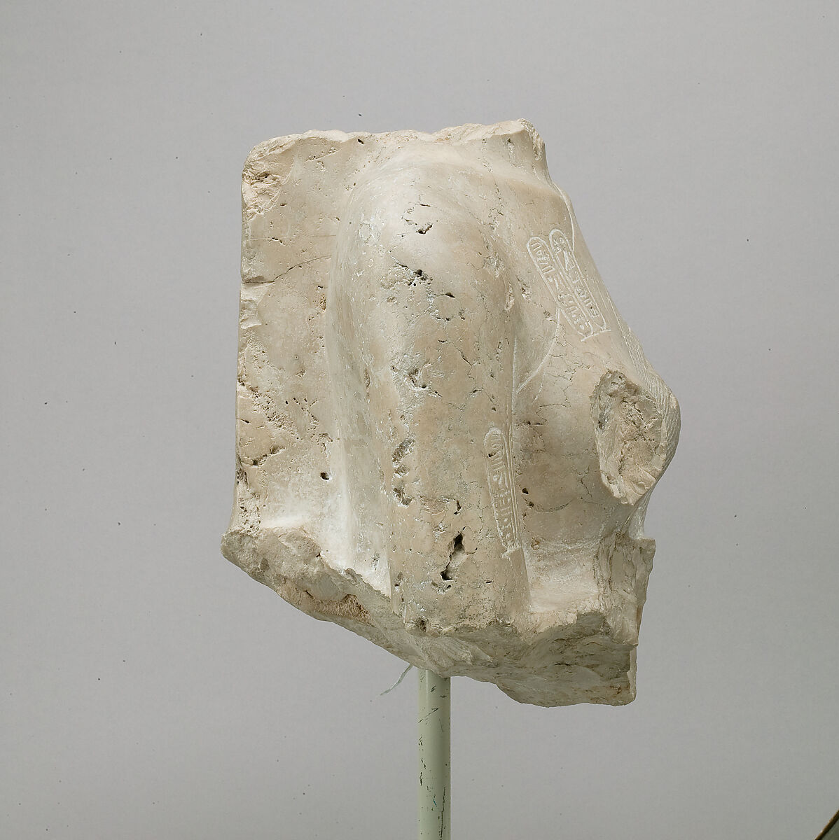 Torso of Nefertiti from a dyad holding a stela in front of the bodies, Indurated limestone