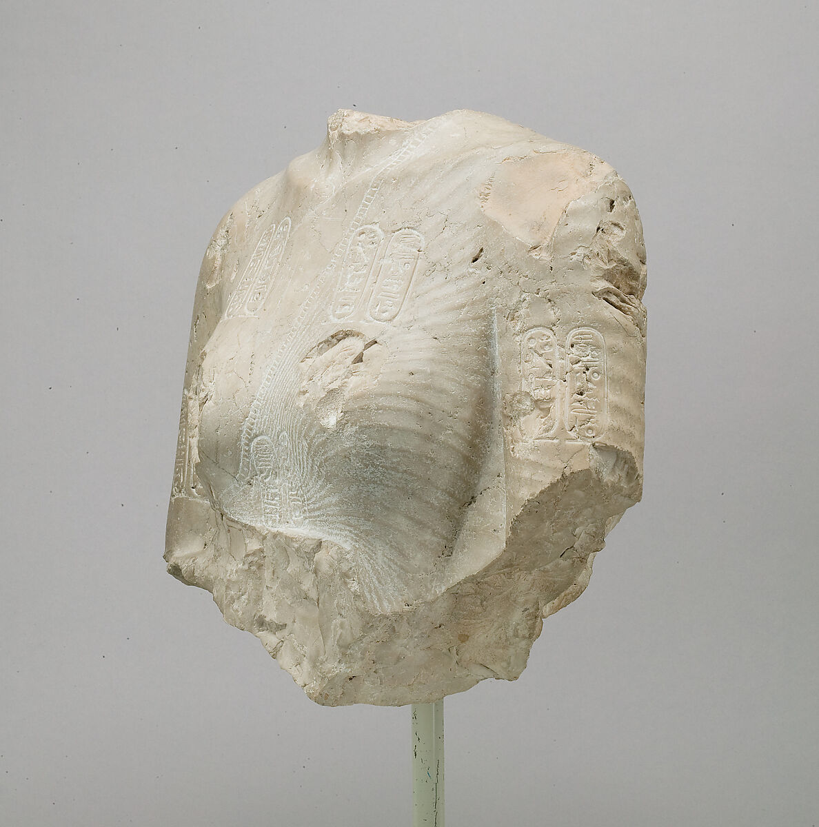 Torso of Nefertiti from a dyad holding a stela in front of the bodies, Indurated limestone