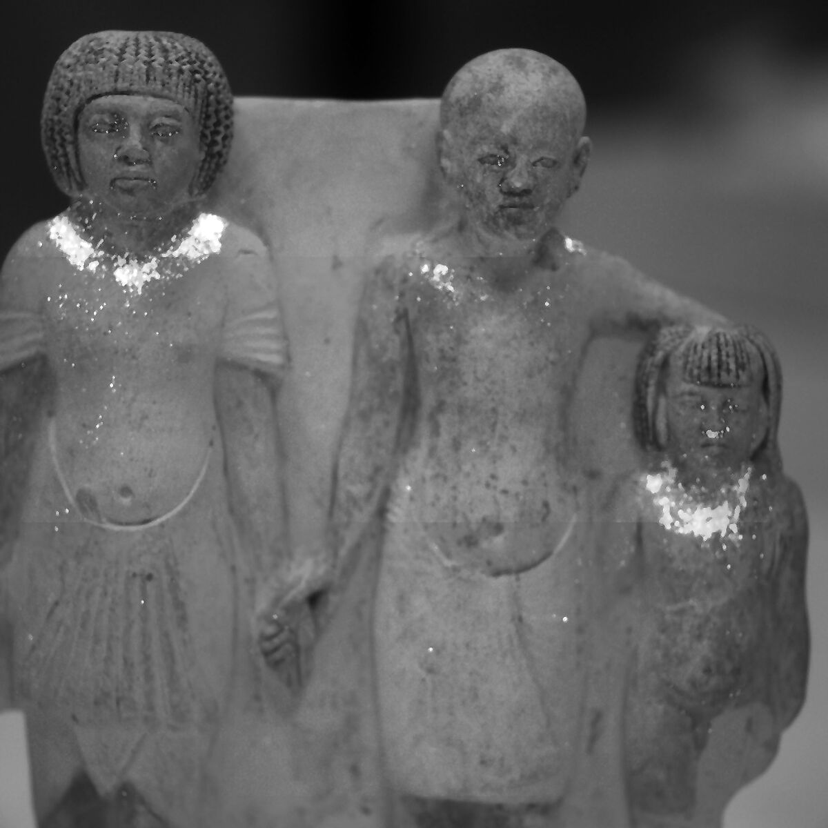 Statue of two men and a boy that served as a domestic icon, Limestone, paint