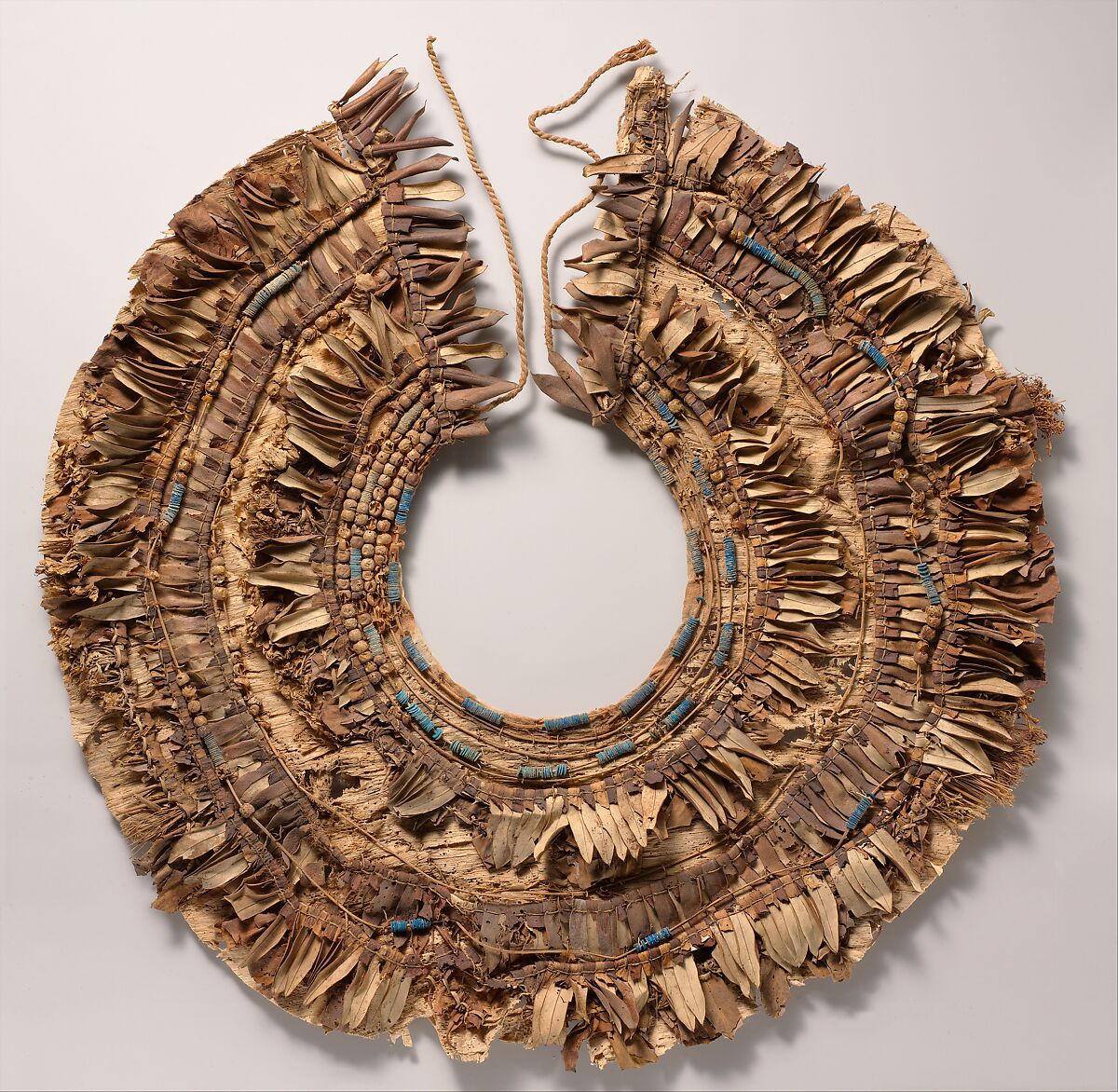 Floral collar from Tutankhamun's Embalming Cache, Papyrus, olive leaves, persea leaves, nightshade berries, celery (?), faience, linen dyed red 