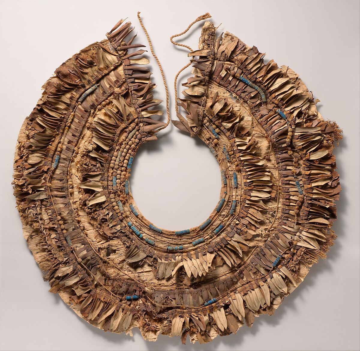 Floral collar from Tutankhamun's Embalming Cache, Papyrus, olive leaves, persea leaves, nightshade berries, celery (?), faience, linen dyed red