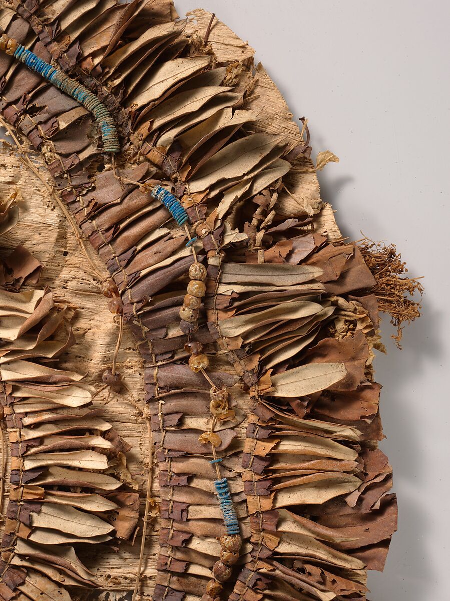 Floral collar from Tutankhamun's Embalming Cache, Papyrus, olive leaves, persea leaves, nightshade berries, celery (?), faience, linen dyed red