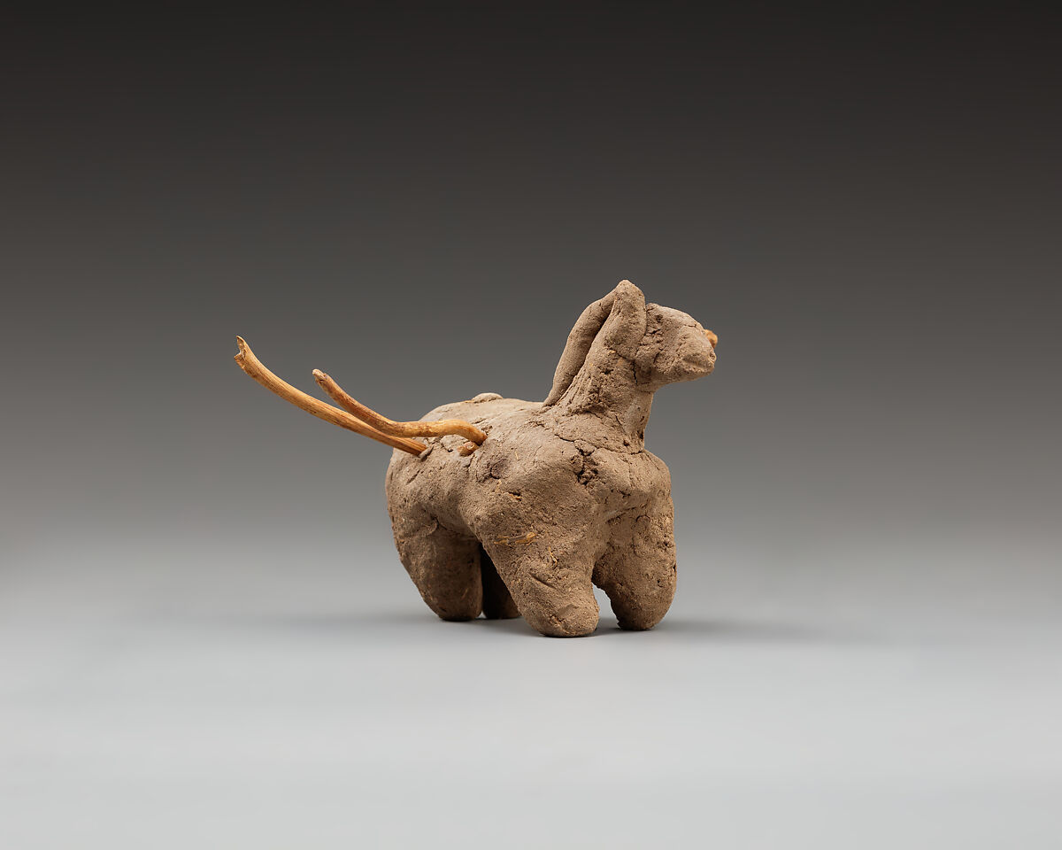 Donkey with packs on its back, Clay, twigs