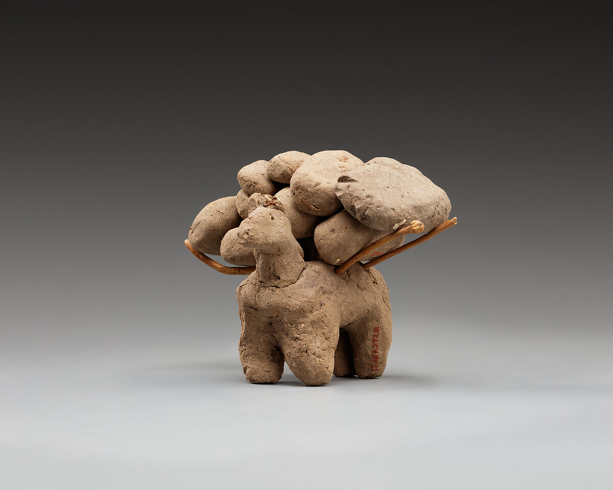 Donkey with packs on its back, Clay, twigs