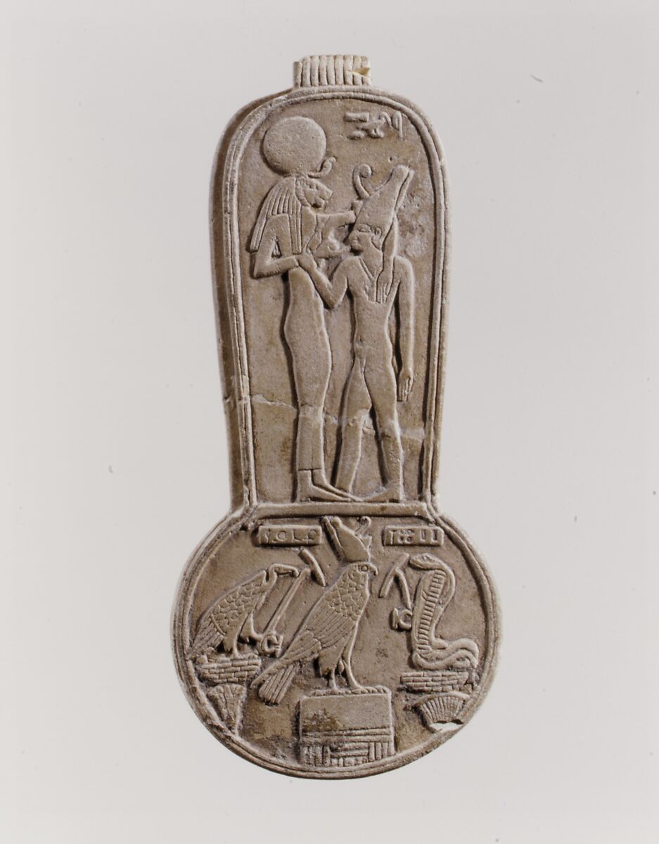 Counterweight of a <em>menit</em> necklace with an image of Bastet nursing King Taharqo, Faience