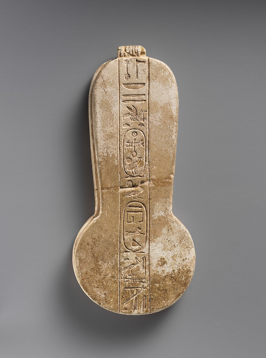Counterweight of a <em>menit</em> necklace with an image of Bastet nursing King Taharqo, Faience