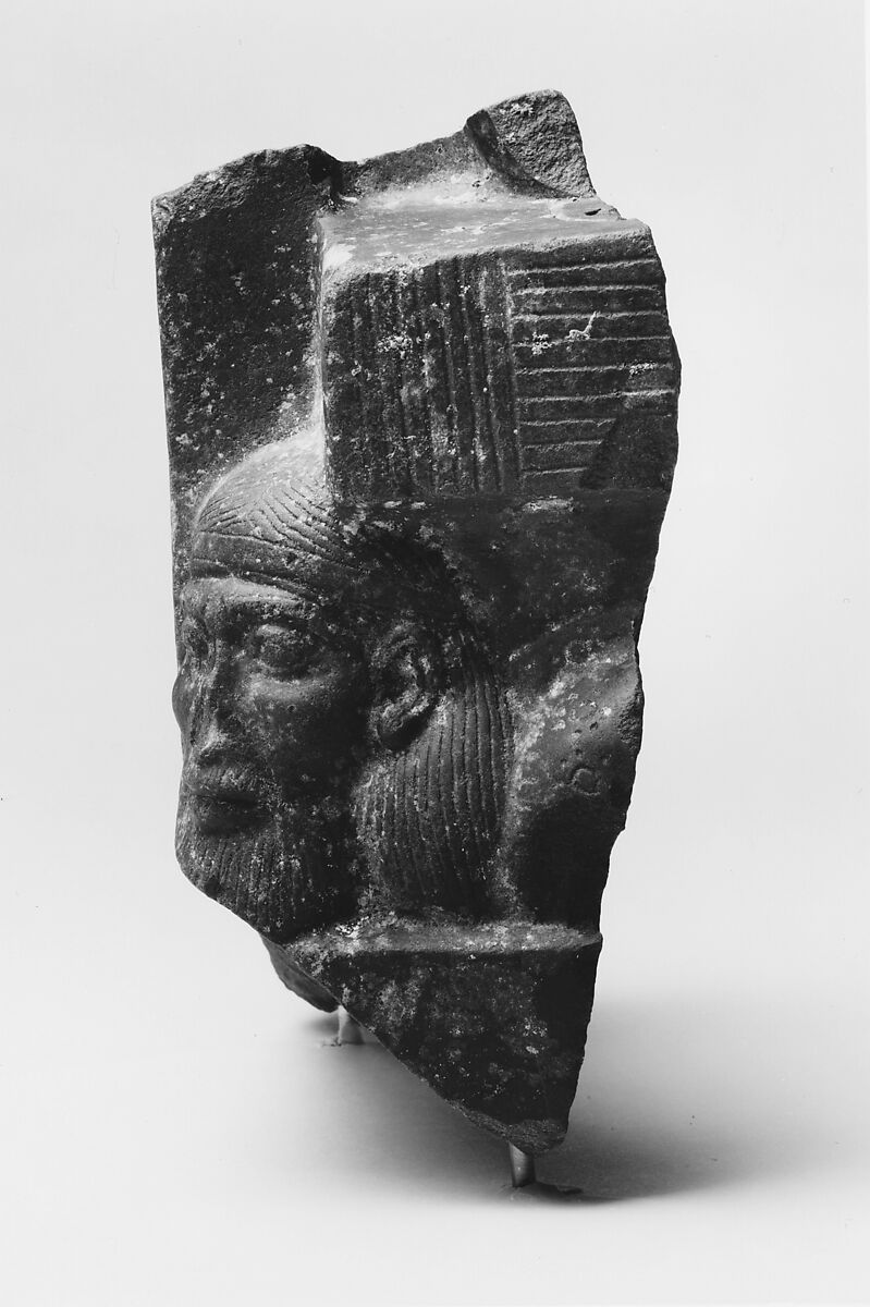 Fragment of a sculptured statue base depicting an Asiatic prisoner, Schist
