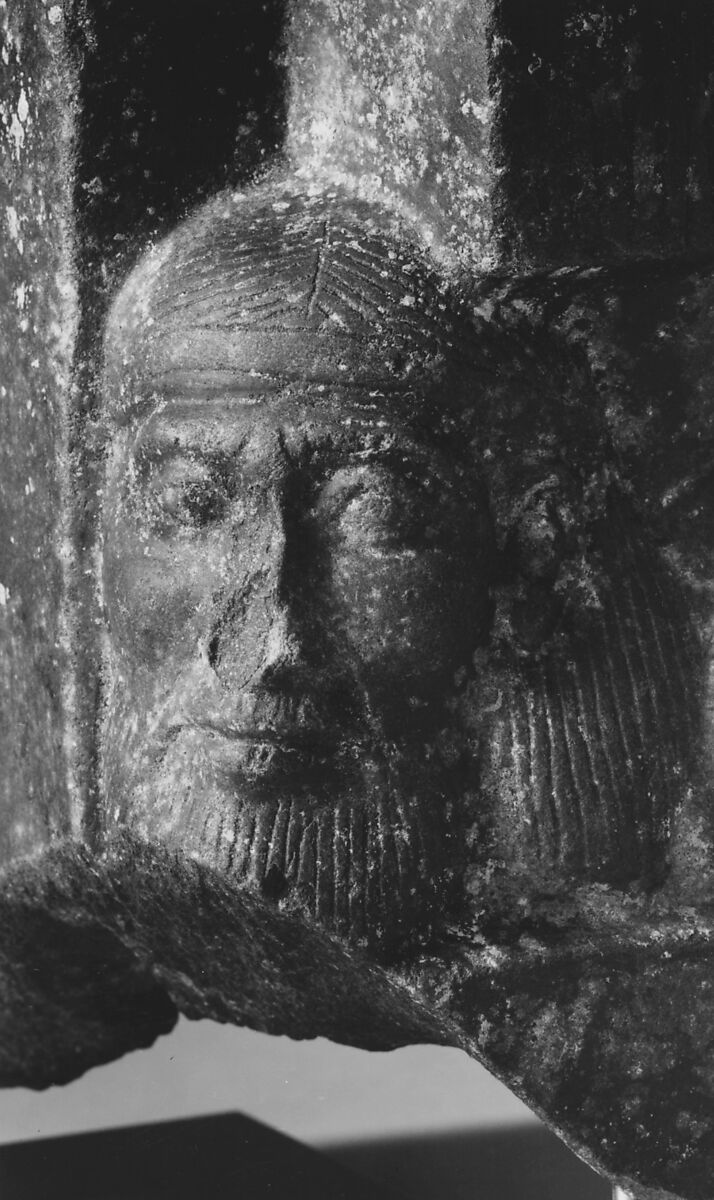 Fragment of a sculptured statue base depicting an Asiatic prisoner, Schist