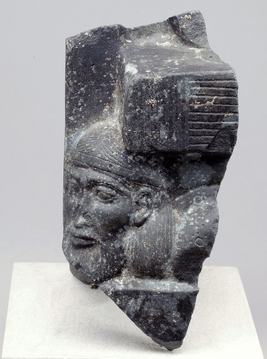 Fragment of a sculptured statue base depicting an Asiatic prisoner, Schist