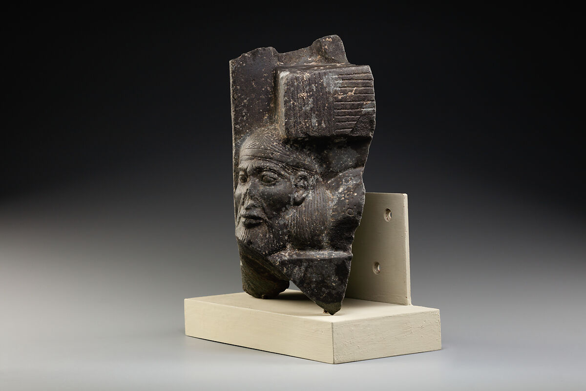 Fragment of a sculptured statue base depicting an Asiatic prisoner, Schist