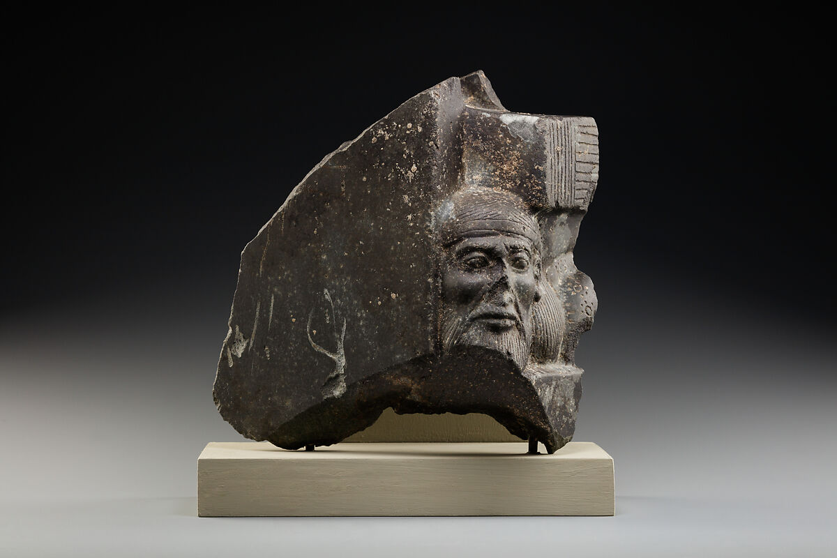 Fragment of a sculptured statue base depicting an Asiatic prisoner, Schist 