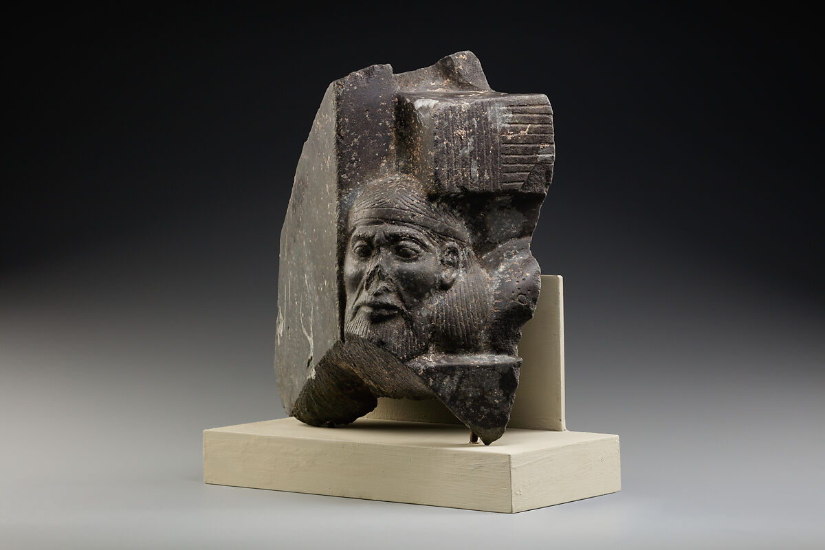 Fragment of a sculptured statue base depicting an Asiatic prisoner, Schist