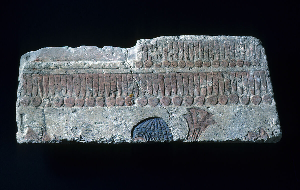 Relief with man carrying papyrus bundle, Limestone, paint (mostly modern) 