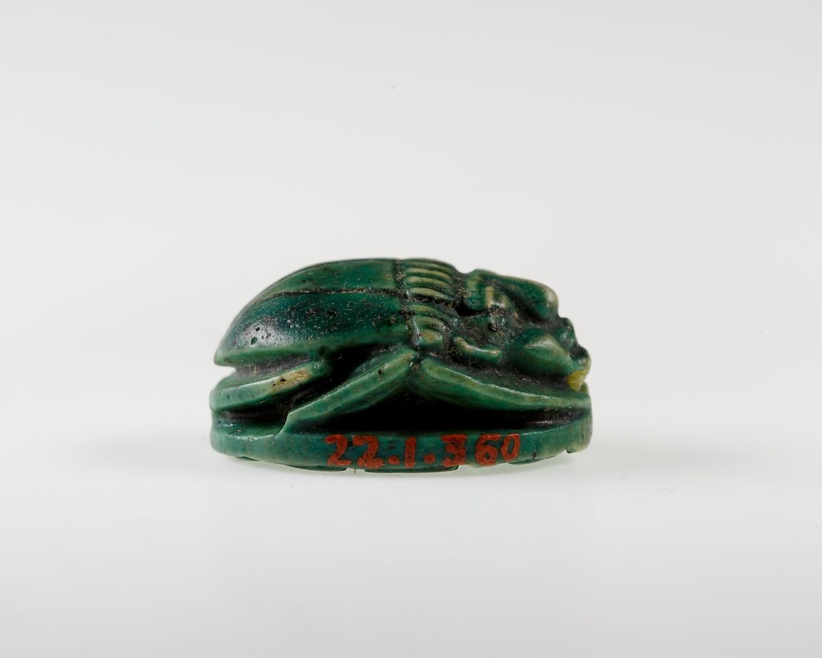 Human-face Scarab with Sphinx and Hieroglyphs, Dark green glazed steatite