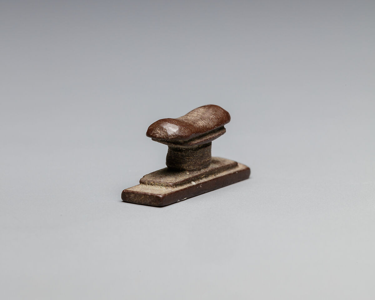 Headrest amulet, Stone