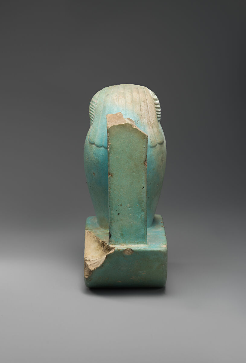 Figure of baboon on a basket and with a pillar (<em>shebet</em> offering), Faience, pale blue glaze