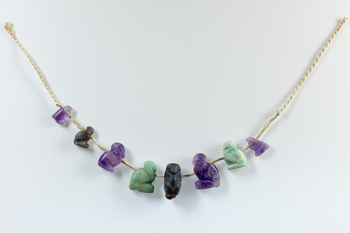 String of 1 squatting ape, 5 Ba birds, and 2 Horus amulets, Lapis lazuli, amethyst, feldspar