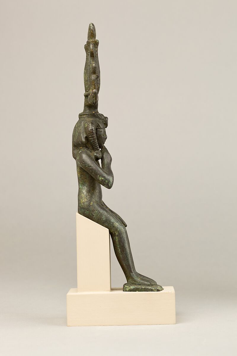 Child god in <em>nemes</em> and <em>hemhem</em> crown, Cupreous metal