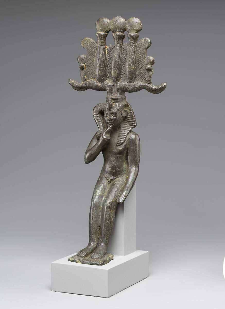 Child god in <em>nemes</em> and <em>hemhem</em> crown, Cupreous metal