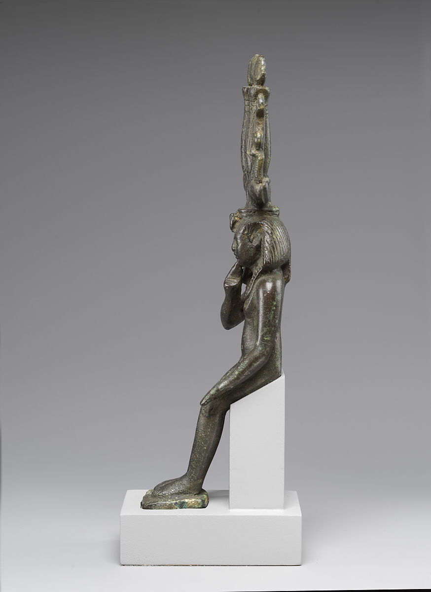 Child god in <em>nemes</em> and <em>hemhem</em> crown, Cupreous metal