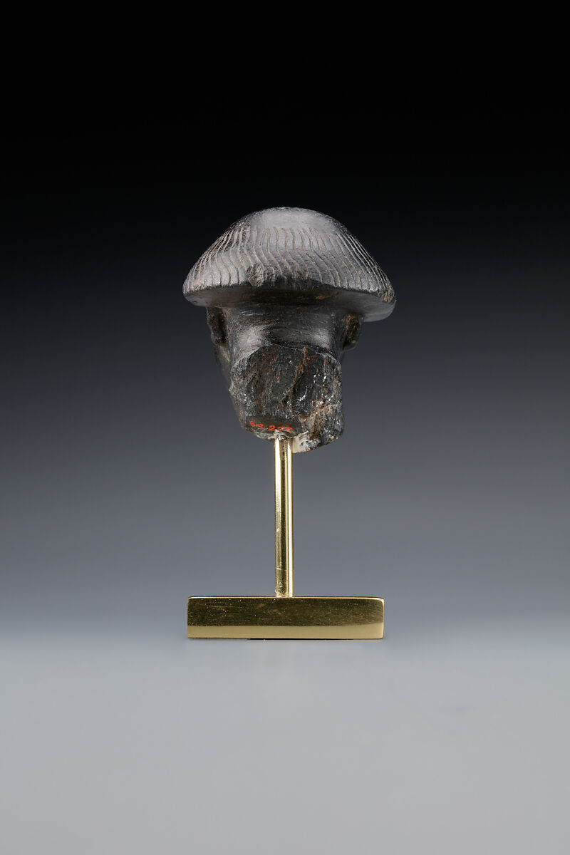 Head fragment from a statuette depicting a "Bald one of Hathor" priest, Steatite